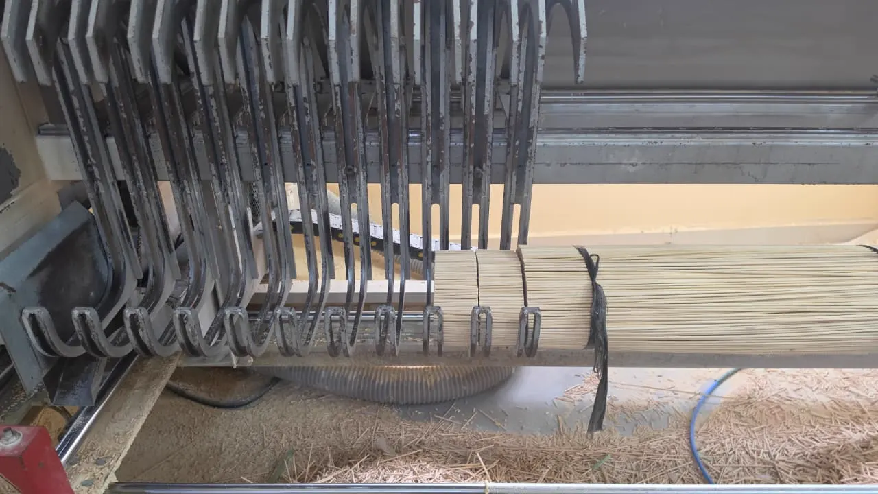 Bundle of bamboo filaments clamped in the length-cutting machine