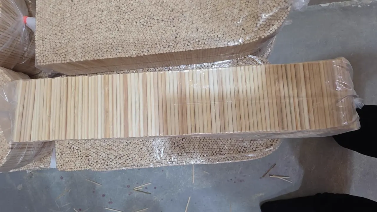 Counted bamboo chopsticks and skewers bagged in bulk packs on the packing floor